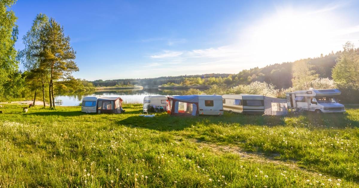 familie vakantie op een camping met caravans en campers rondom een meer